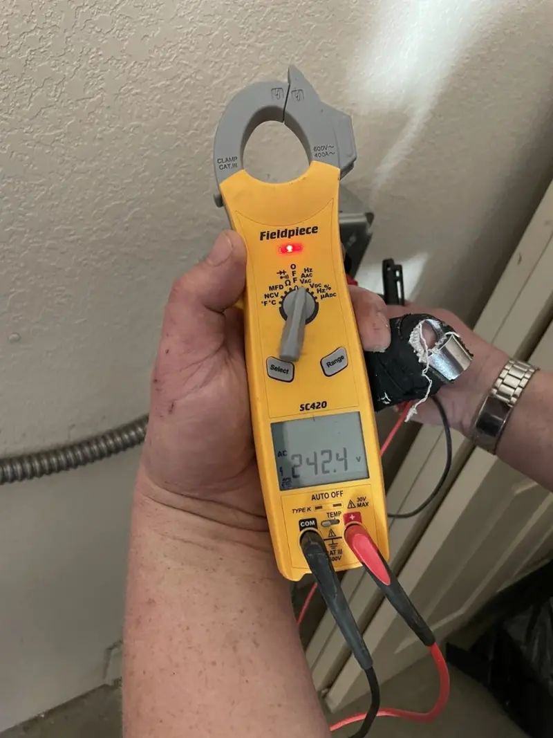 Voltage testing with clamp meter during Recessed Lighting Installation in Brecksville